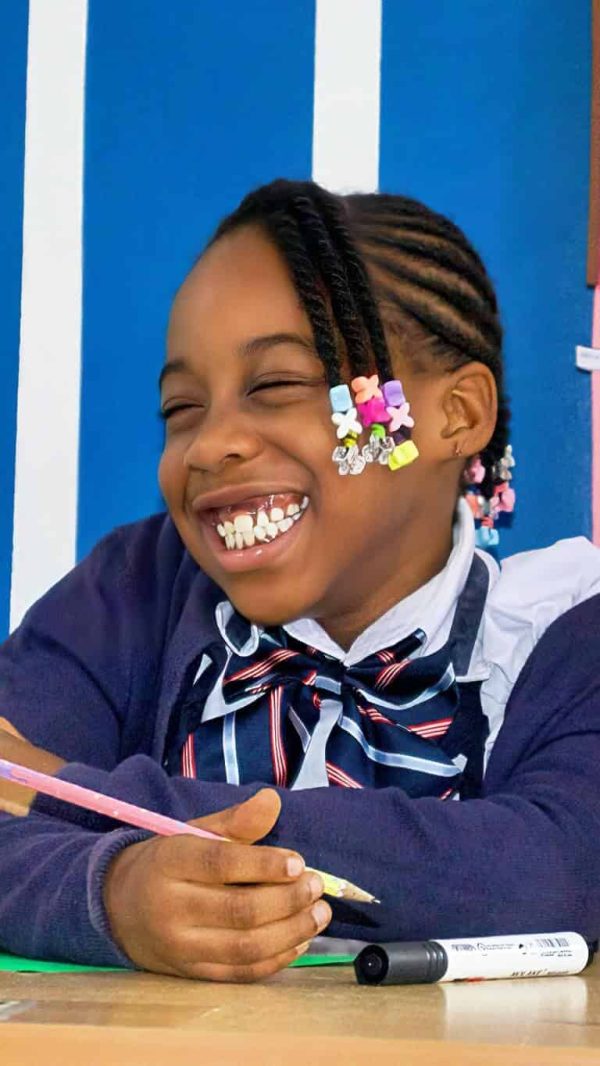 student smiling in learning hive christian academy